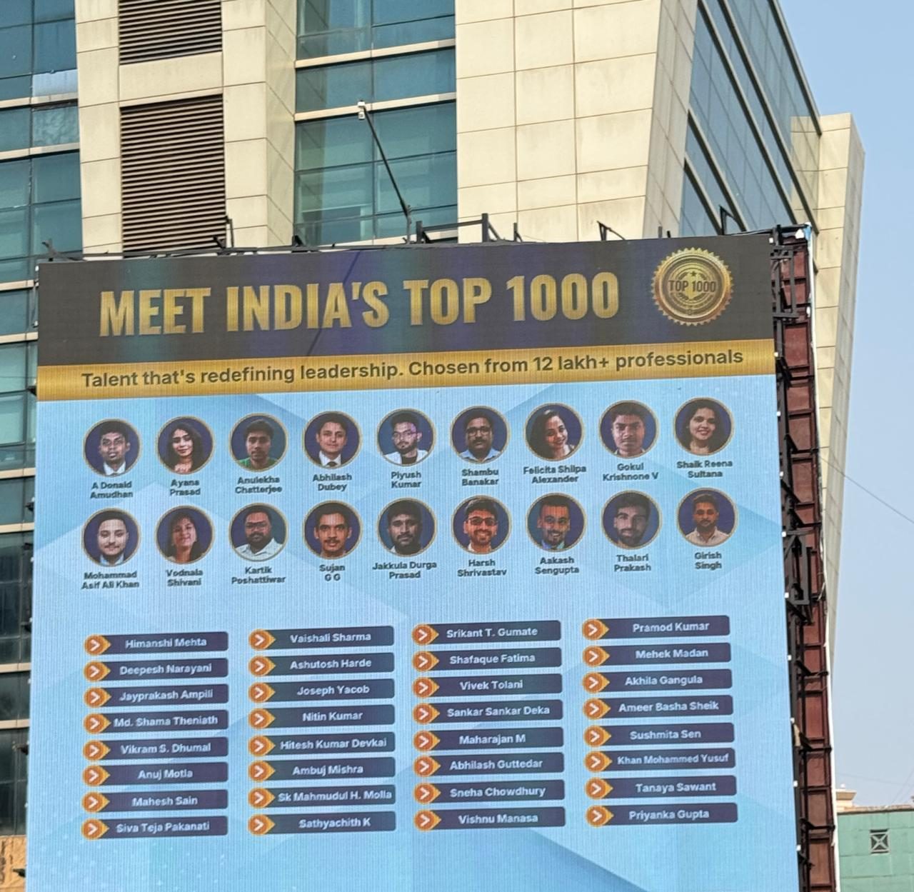 Mumbai billboard titled Meet India's Top 1000, showing Piyush Kumar among the featured professionals